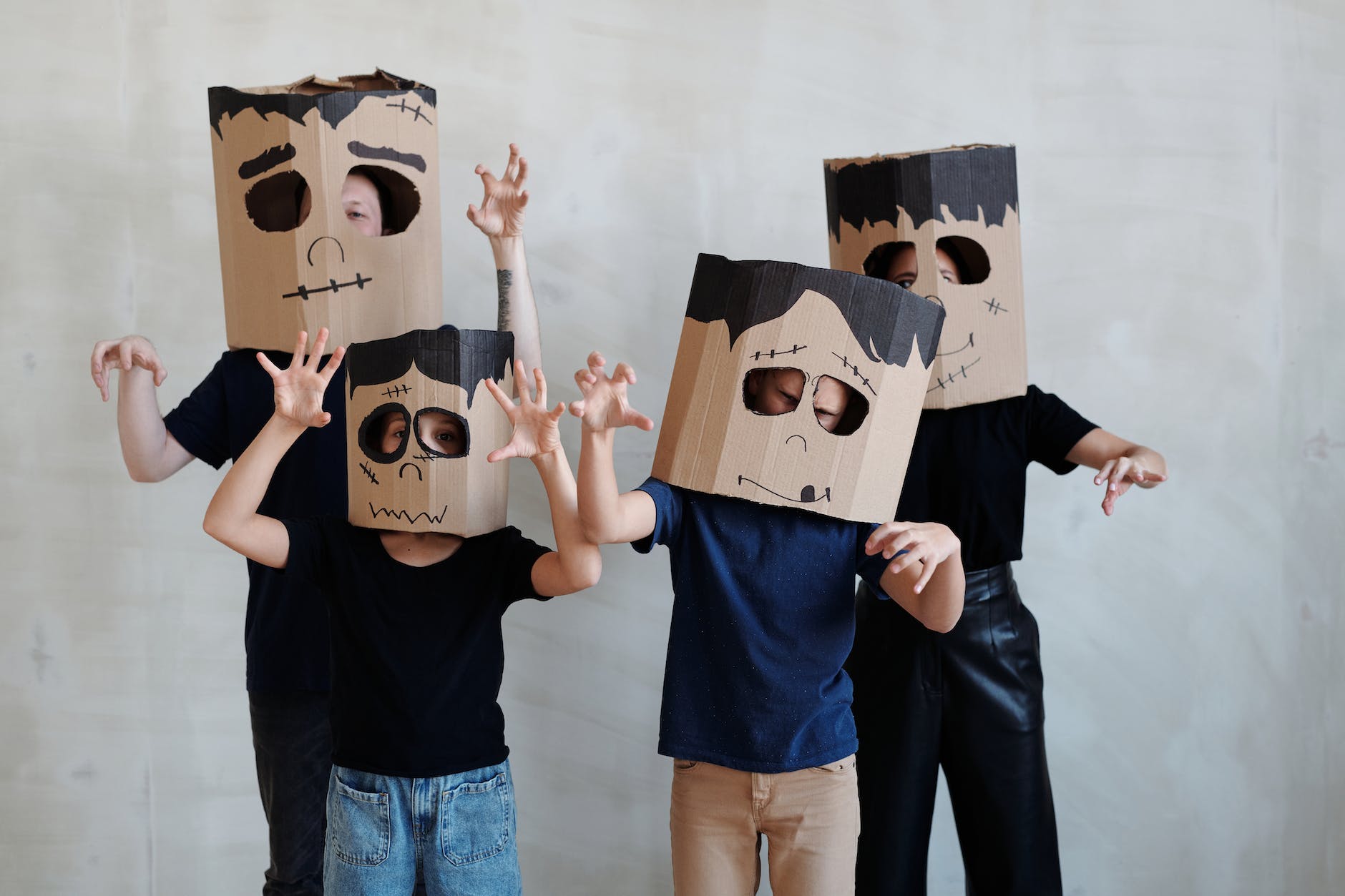Eco-friendly Halloween- a family wearing a diy cardboard box mask